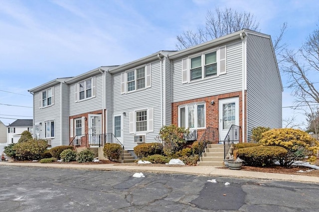 townhome / multi-family property featuring brick siding