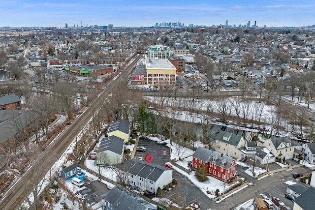 snowy aerial view featuring a view of city