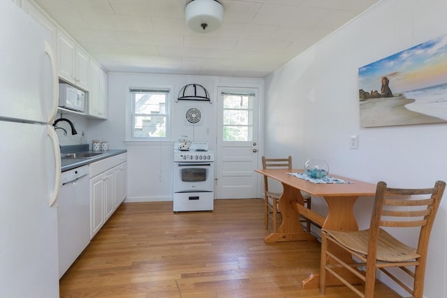 124 Skiff Ave Unit A-11, Tisbury, MA 02568 - kitchen featuring white appliances, light wood-style floors, and white cabinetry