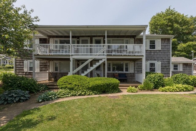 124 Skiff Ave Unit A-11, Tisbury, MA 02568 - back of house featuring stairs, a deck, and a lawn
