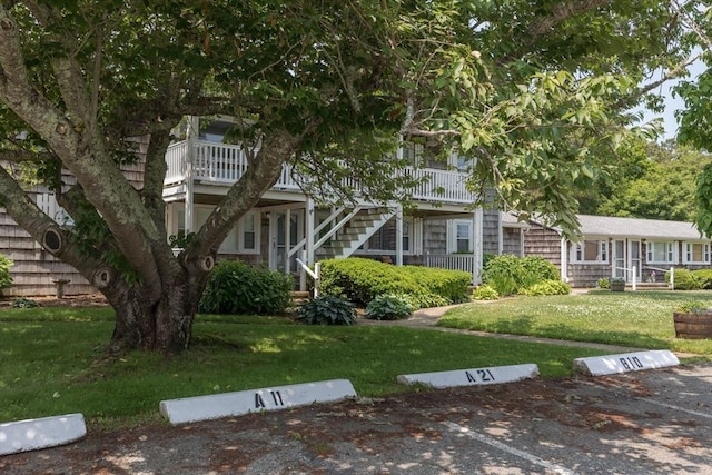 124 Skiff Ave Unit A-11, Tisbury, MA 02568 - obstructed view of property with stairs, uncovered parking, and a front yard