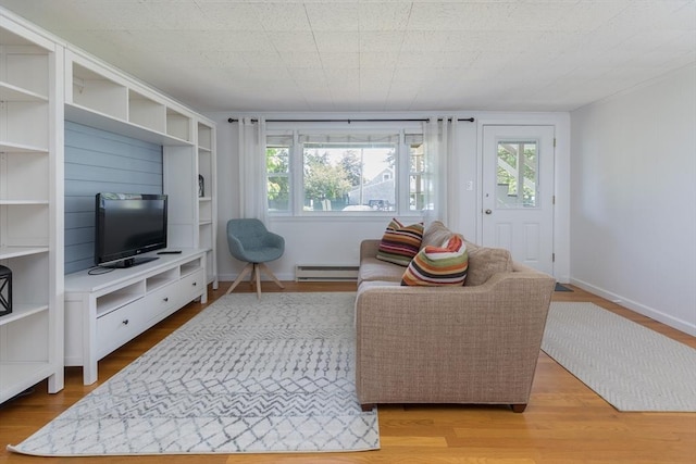 124 Skiff Ave Unit A-11, Tisbury, MA 02568 - living area featuring baseboard heating, plenty of natural light, and wood finished floors