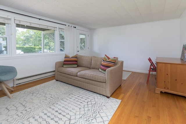 124 Skiff Ave Unit A-11, Tisbury, MA 02568 - living area featuring baseboard heating and light wood-style flooring