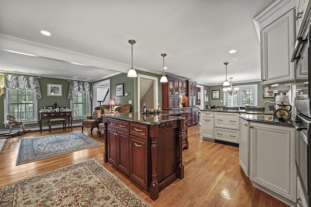 kitchen with white cabinetry, pendant lighting, a wealth of natural light, and open floor plan