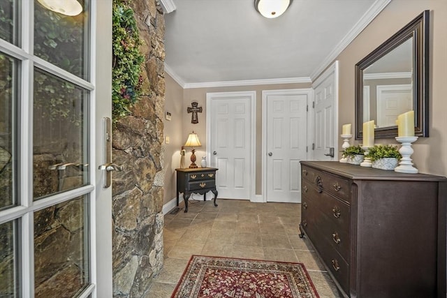 interior space with ornamental molding and baseboards