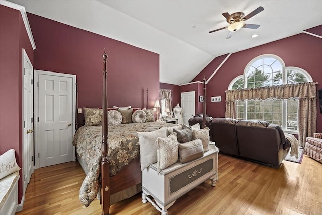 bedroom with ceiling fan, light wood-style flooring, and vaulted ceiling