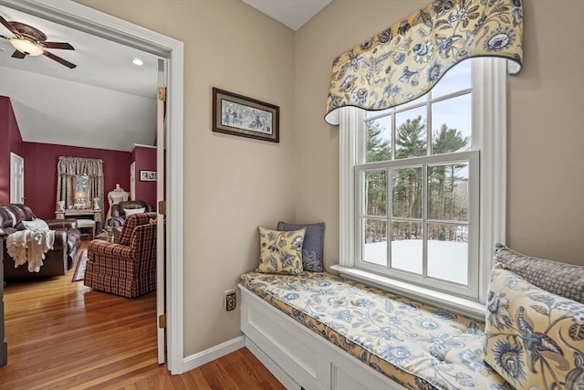 sitting room featuring lofted ceiling, ceiling fan, baseboards, and wood finished floors