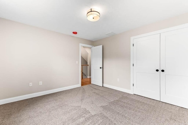 unfurnished bedroom featuring a closet and carpet flooring