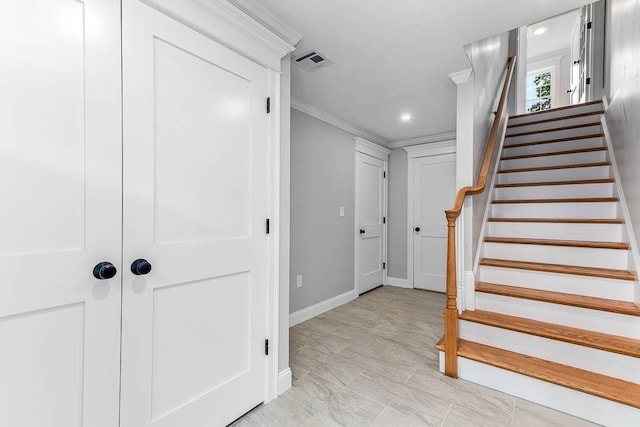 stairway featuring ornamental molding