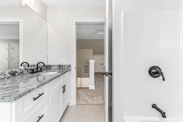 bathroom featuring tile patterned flooring and vanity