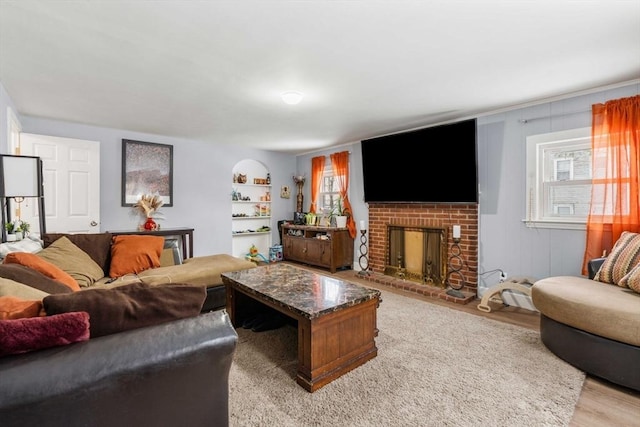 living room with light wood-style flooring and a fireplace