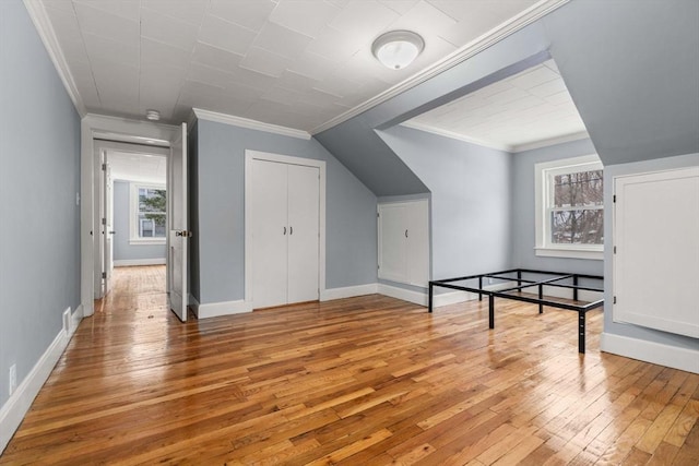 bonus room featuring baseboards and wood finished floors