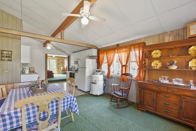 272 Glen Charlie Rd, Wareham, MA 02538 - carpeted dining area with wood walls and a ceiling fan