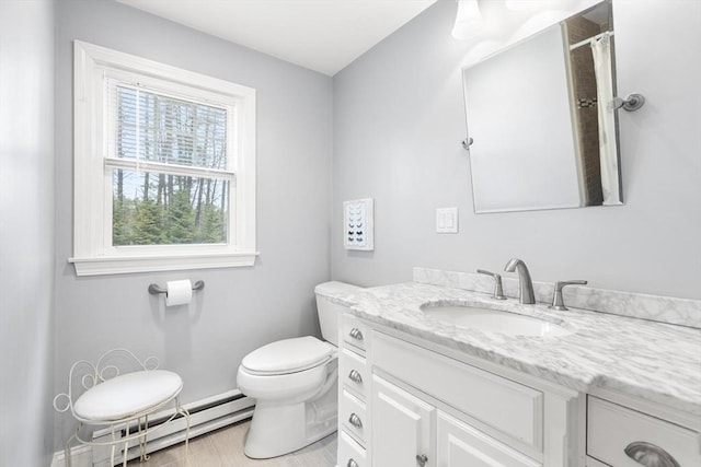 full bath featuring a baseboard heating unit, toilet, and vanity