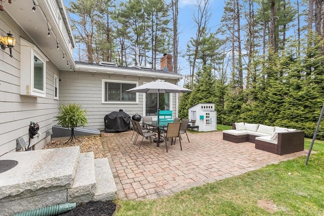 view of patio with a grill, an outdoor hangout area, and outdoor dining space