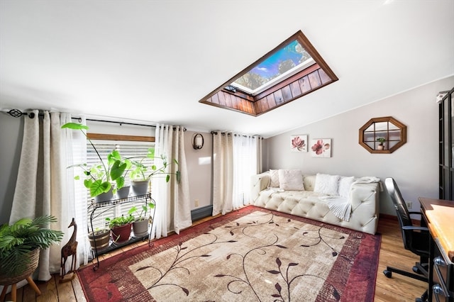 living room with lofted ceiling with skylight and wood-type flooring