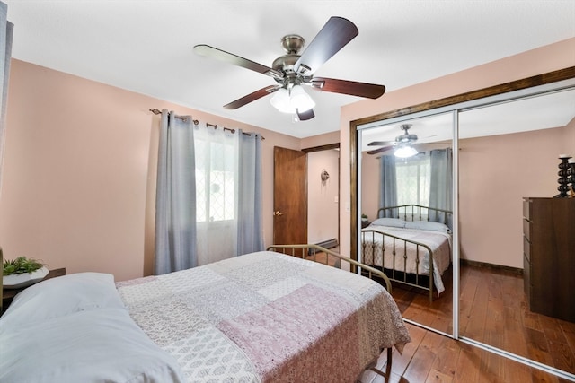 bedroom with ceiling fan, a closet, and wood-type flooring