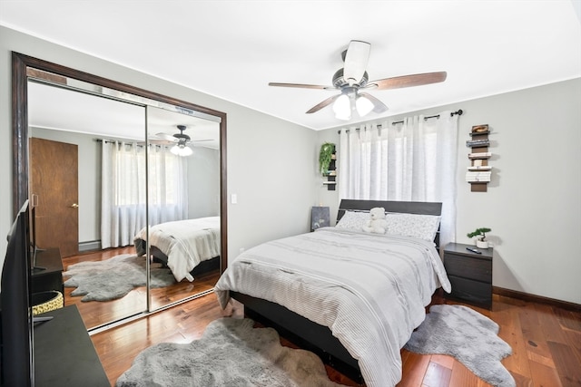 bedroom with ceiling fan, a closet, and wood-type flooring