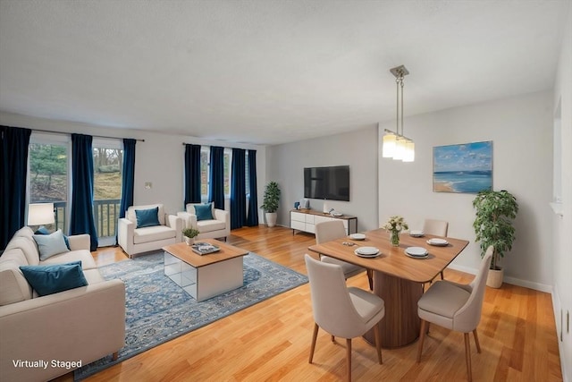 dining space with wood finished floors and baseboards