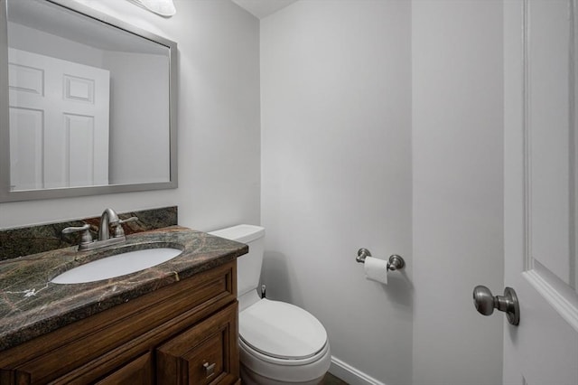 bathroom featuring toilet and vanity