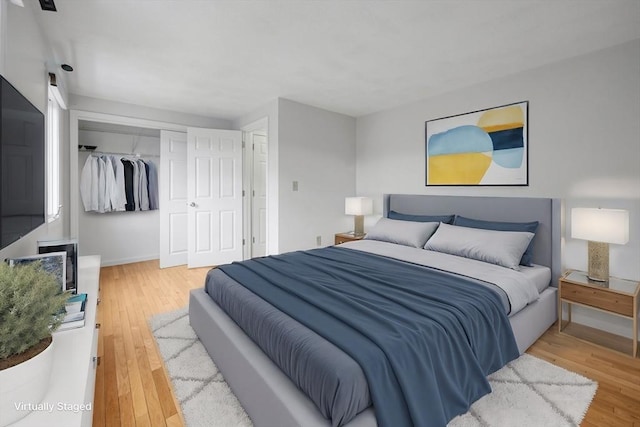 bedroom featuring a closet and light wood-style floors