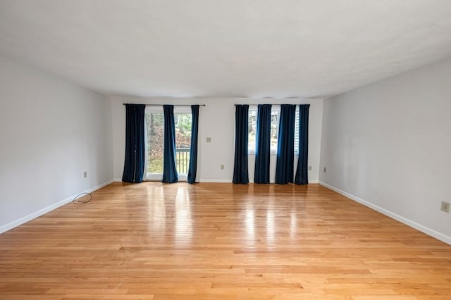 unfurnished room featuring light wood-style flooring and baseboards