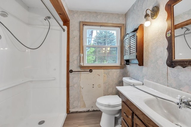 45 Alpine Dr, Southbridge, MA 01550 - bathroom featuring wood finished floors, a shower, vanity, toilet, and wallpapered walls