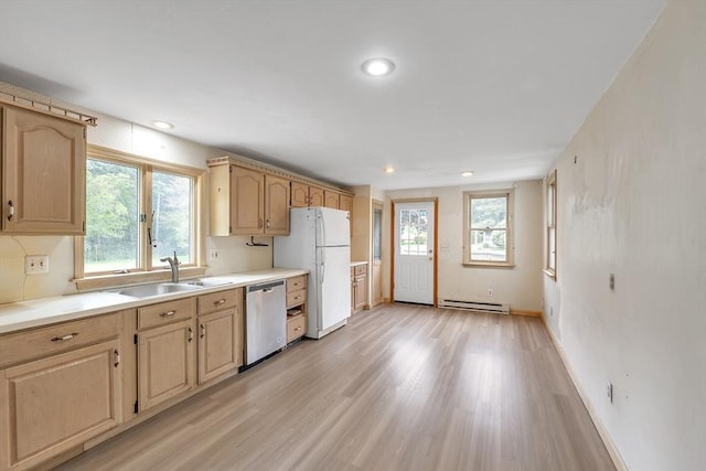 45 Alpine Dr, Southbridge, MA 01550 - kitchen with stainless steel dishwasher, a baseboard heating unit, a sink, freestanding refrigerator, and light brown cabinetry