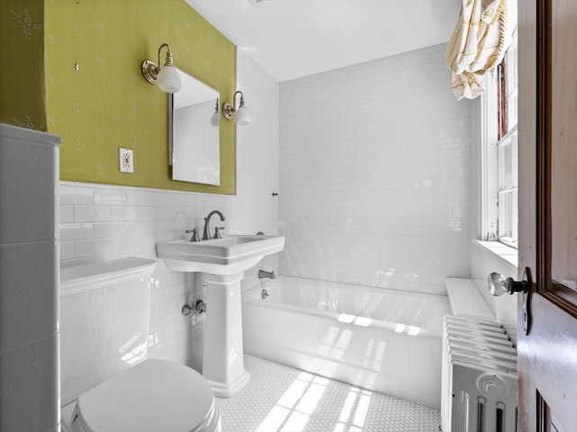 full bath with toilet, a sink, a wainscoted wall, tile walls, and radiator heating unit
