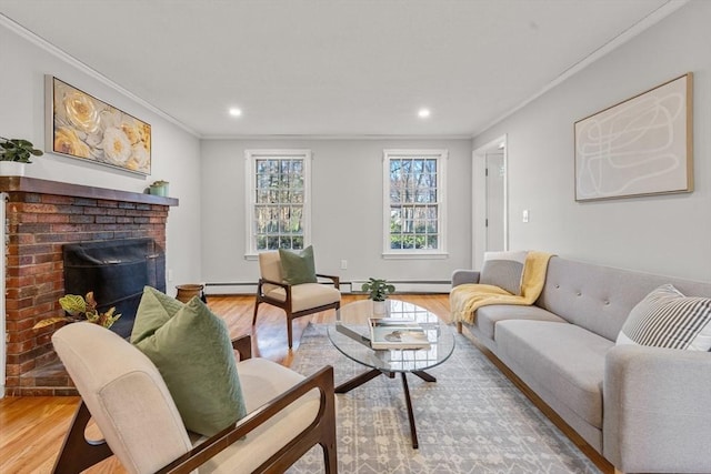 living room featuring a brick fireplace, a baseboard heating unit, light hardwood / wood-style floors, and crown molding