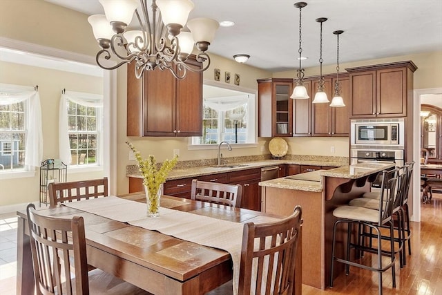 2 Rich Rd, Milford, MA 01757 - kitchen with a sink, appliances with stainless steel finishes, a kitchen island, and a healthy amount of sunlight