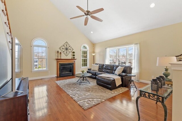 2 Rich Rd, Milford, MA 01757 - living room featuring a fireplace with flush hearth, high vaulted ceiling, wood-type flooring, and a healthy amount of sunlight