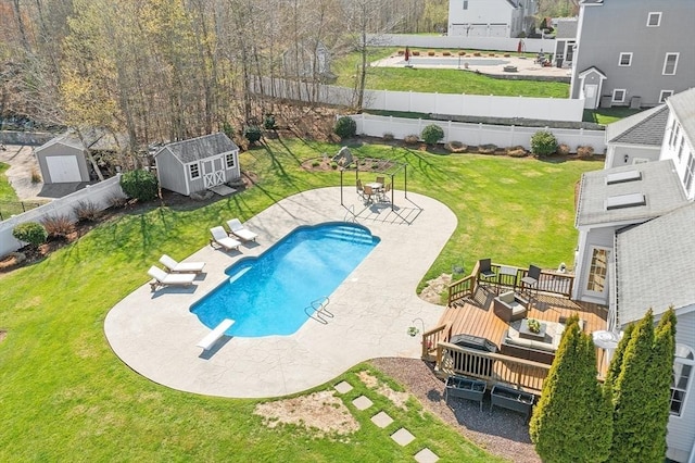2 Rich Rd, Milford, MA 01757 - view of pool with a lawn, a diving board, a wooden deck, an outdoor structure, and a fenced backyard