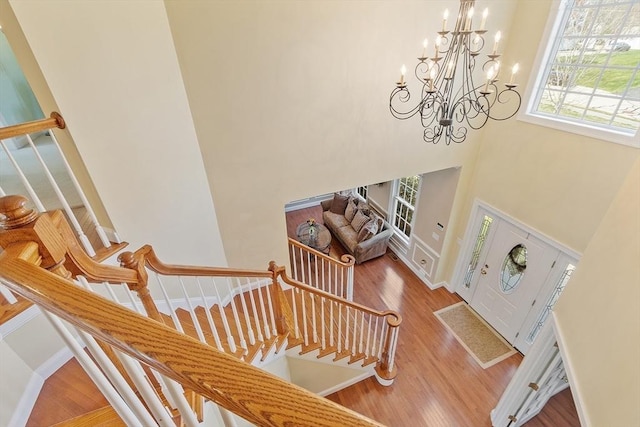 2 Rich Rd, Milford, MA 01757 - stairway featuring an inviting chandelier, a high ceiling, wood finished floors, and a wealth of natural light