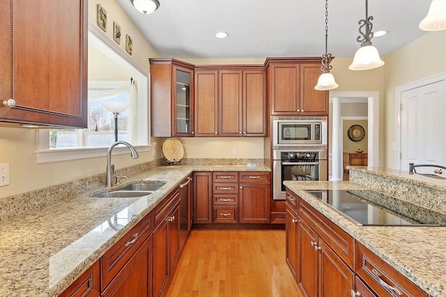 2 Rich Rd, Milford, MA 01757 - kitchen featuring light stone counters, a sink, light wood-style flooring, hanging light fixtures, and stainless steel appliances
