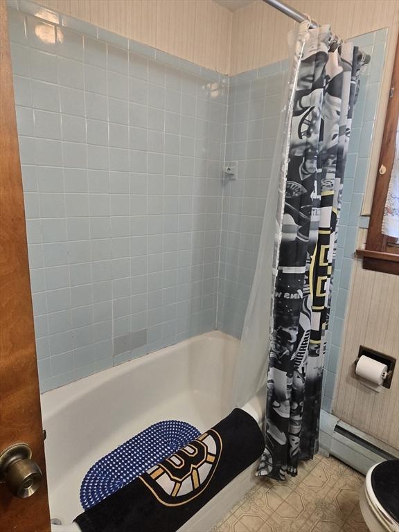 full bathroom featuring shower / bathtub combination with curtain, baseboard heating, and toilet
