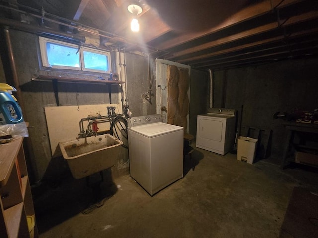 basement featuring washer and dryer and a sink