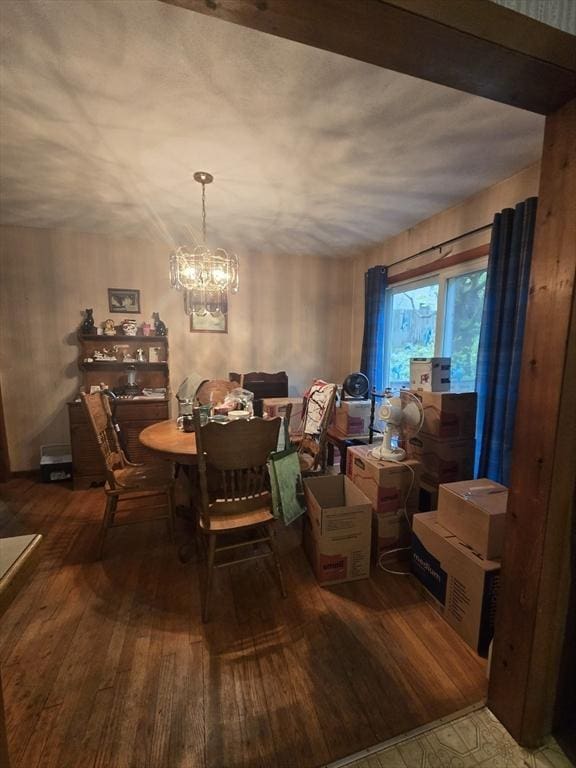 dining room with hardwood / wood-style flooring and a chandelier