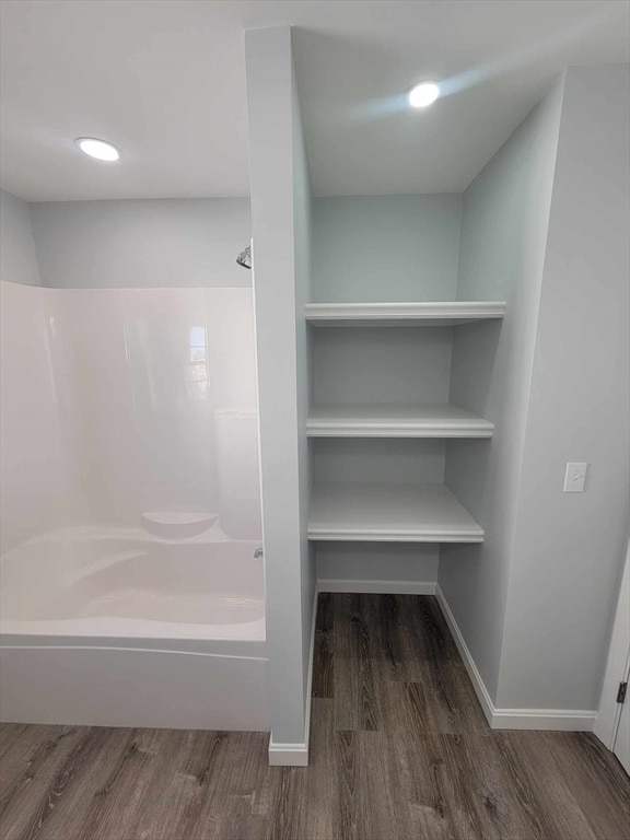 bathroom featuring wood-type flooring and shower / bath combination