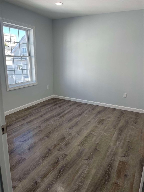 spare room with dark hardwood / wood-style flooring