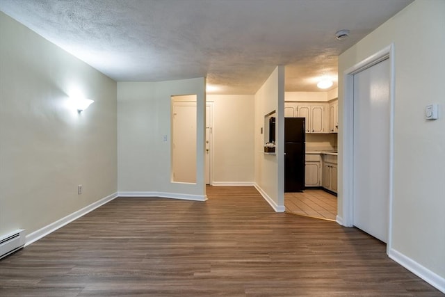 915 Edgell Rd Unit 85, Framingham, MA 01701 - unfurnished living room with a baseboard radiator and dark wood finished floors