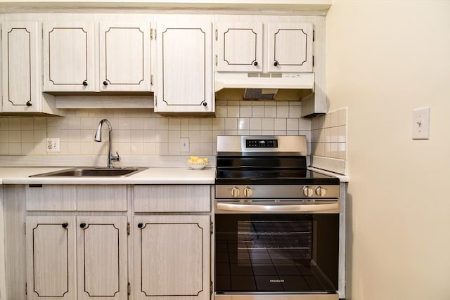 915 Edgell Rd Unit 85, Framingham, MA 01701 - kitchen featuring electric stove, under cabinet range hood, light countertops, and backsplash