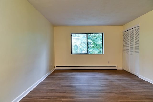 915 Edgell Rd Unit 85, Framingham, MA 01701 - unfurnished bedroom with baseboard heating, wood finished floors, and a closet