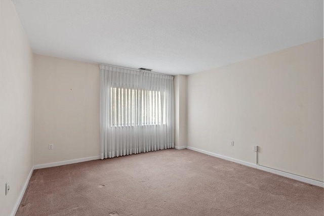 empty room with light colored carpet