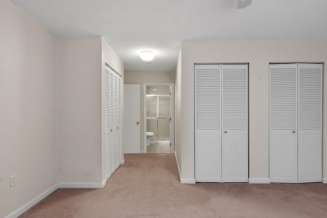 hall with light colored carpet