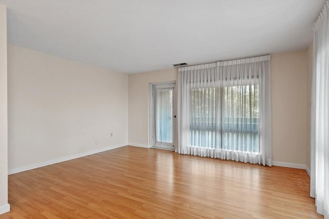 spare room featuring light wood-type flooring