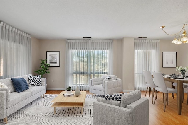 living room featuring light hardwood / wood-style flooring and a notable chandelier