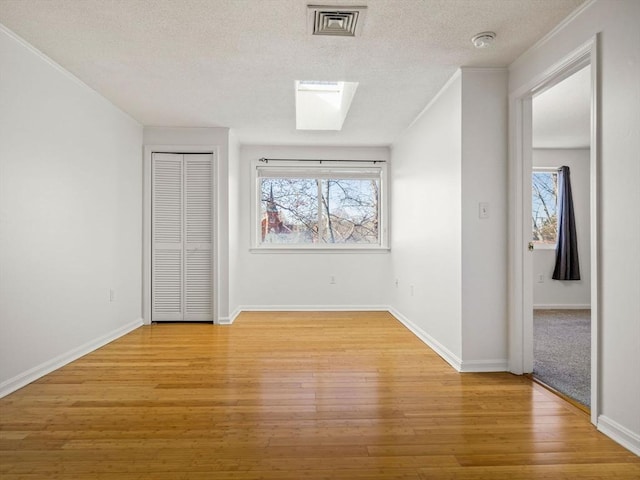 interior space with a wealth of natural light, visible vents, and light wood-style flooring