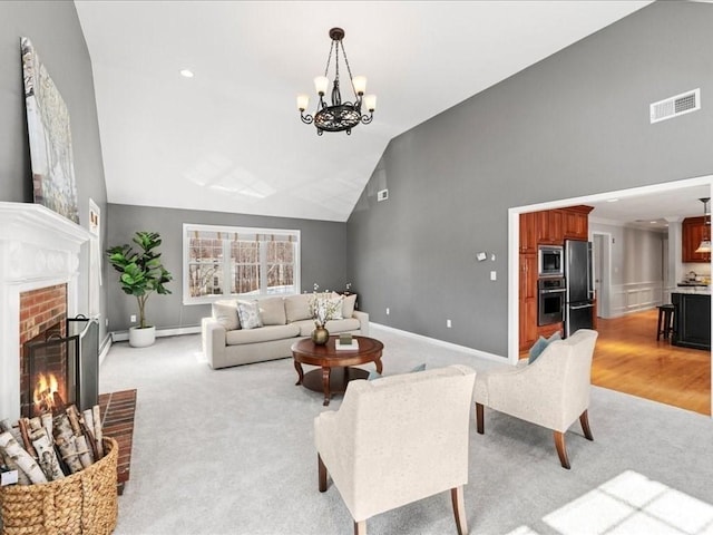 living room with high vaulted ceiling, a fireplace, a baseboard radiator, light colored carpet, and an inviting chandelier