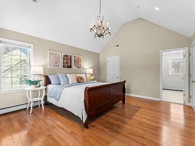 bedroom with an inviting chandelier, hardwood / wood-style floors, high vaulted ceiling, and a baseboard heating unit